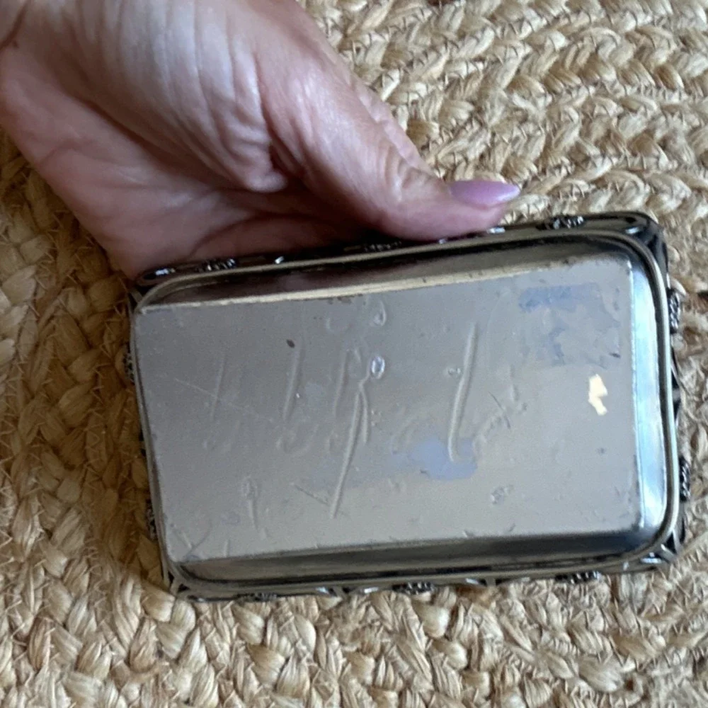 decorative silver-tone pedestal dish, likely used as a soap dish, trinket holder
